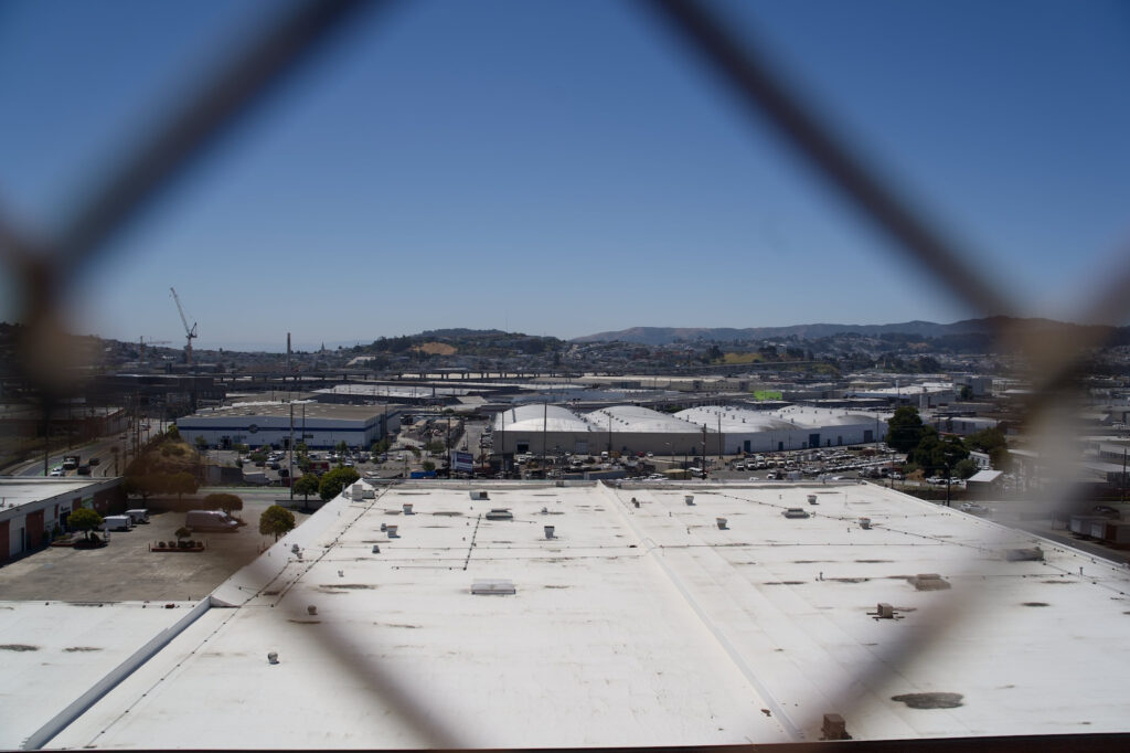 San Francisco view through a fence, overlooking industrial area and raw sewage plant